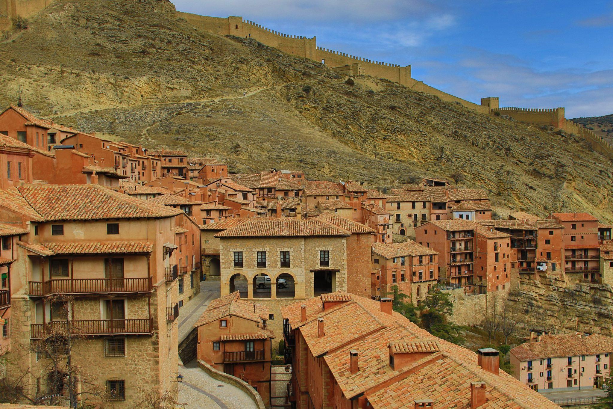 Reddish rooftops of Albarracín with the town walls climbing the hillside
